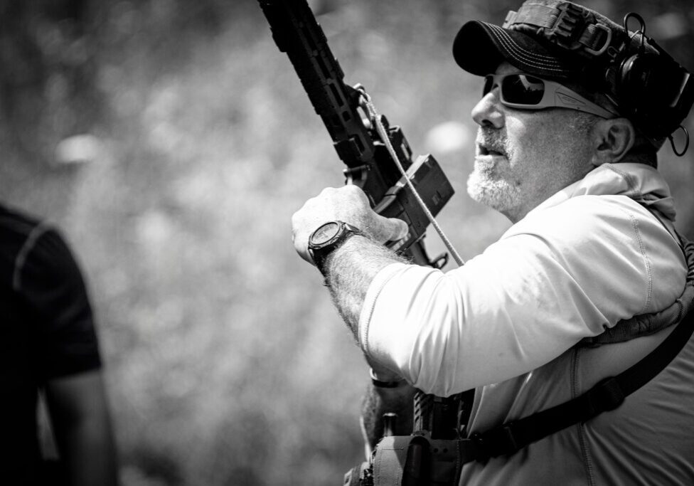 A man holding a rifle in his hand.