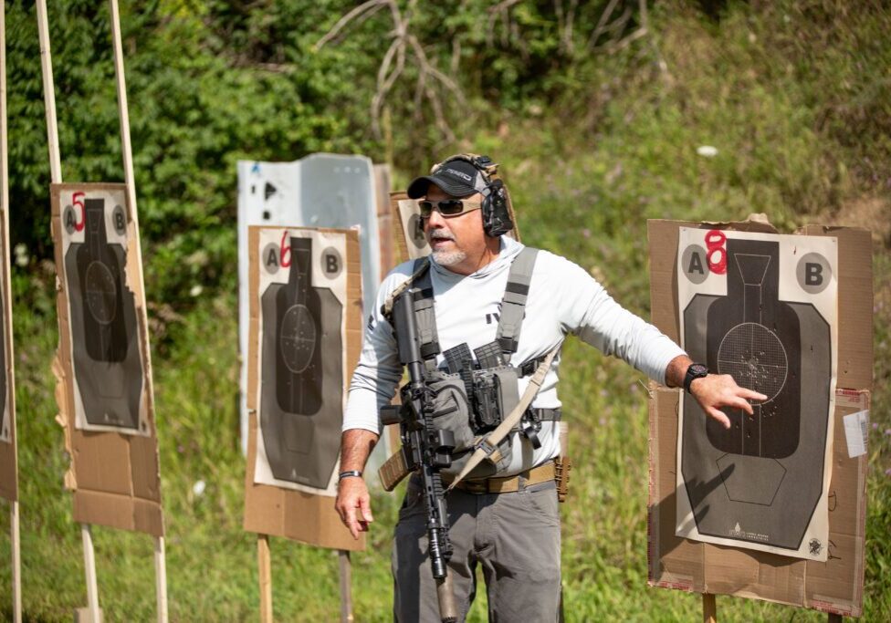 A man is standing in front of some targets