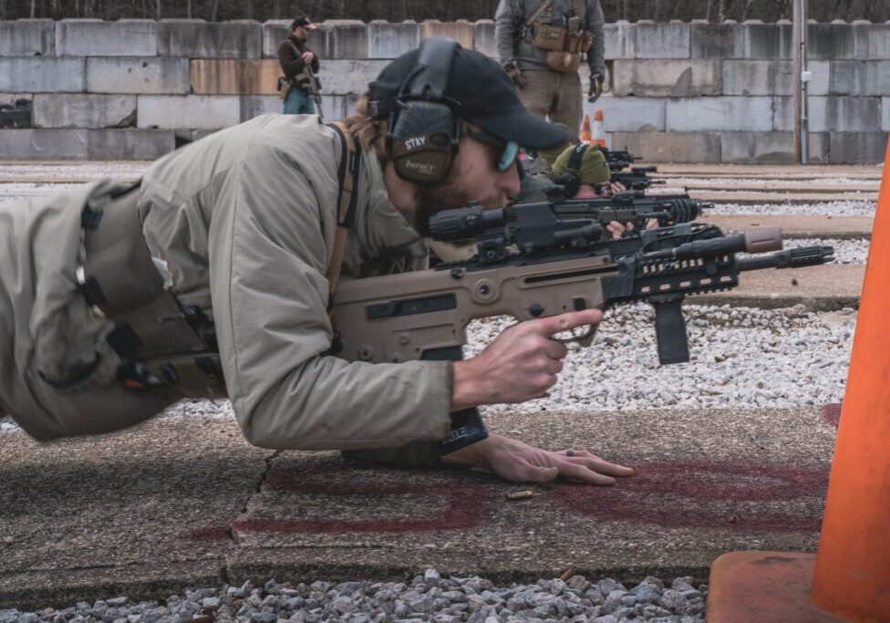 A man with a rifle on the ground