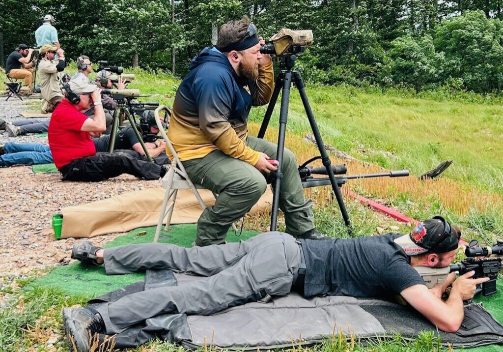 A man sitting on the ground with a camera.